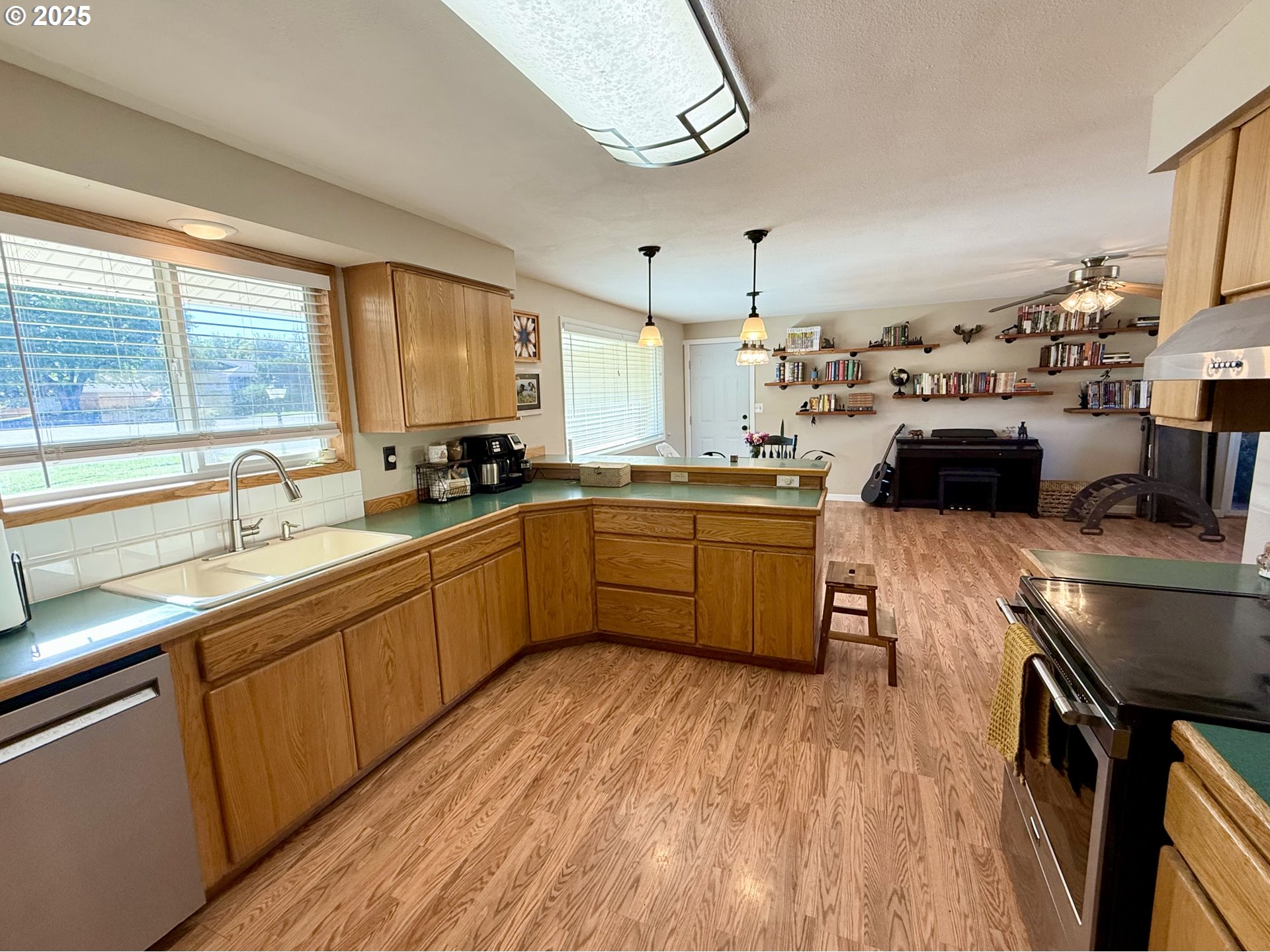 1317 Vita Court Pendleton, OR 97801 - Photo 18 of 32 a kitchen with stainless steel appliances a sink a stove a refrigerator cabinets and a large window