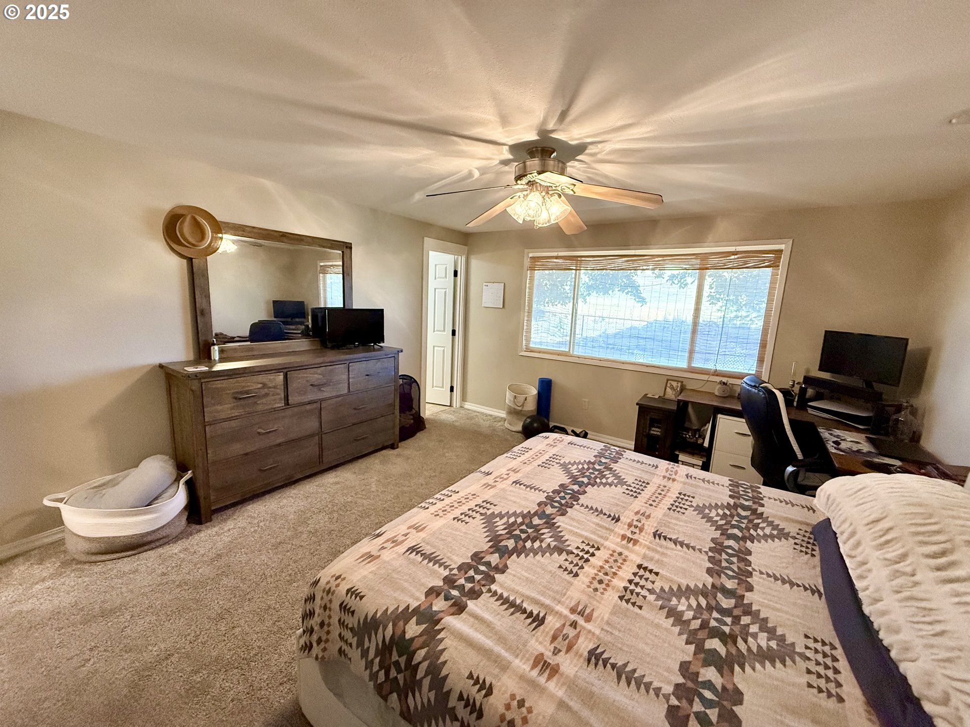 1317 Vita Court Pendleton, OR 97801 - Photo 22 of 32 a bedroom with a bed a large window and flat screen tv