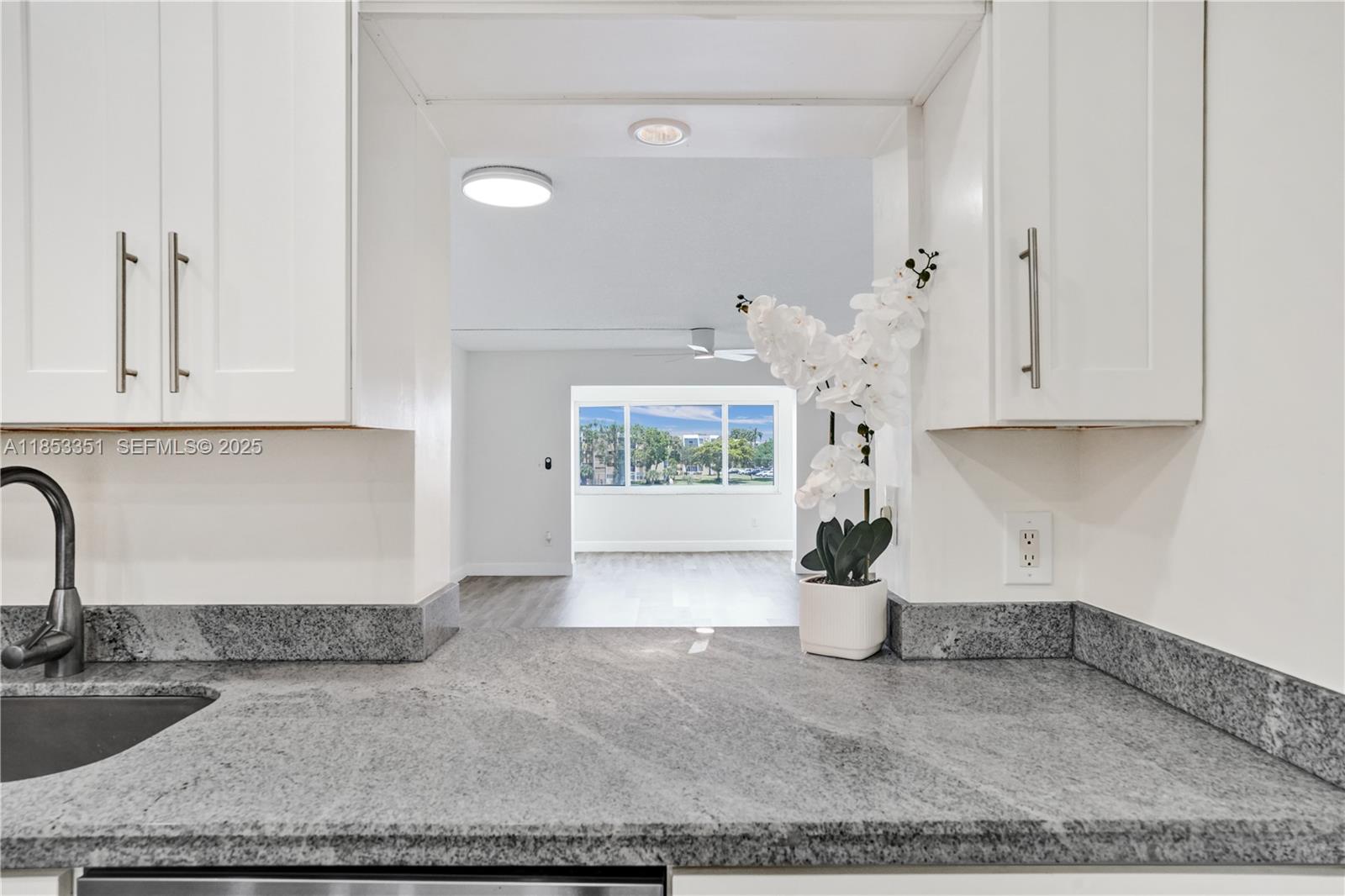873 Northeast 195th Street, Unit 309 North Miami Beach, FL 33179 - Photo 11 of 35 a kitchen with a sink and cabinets