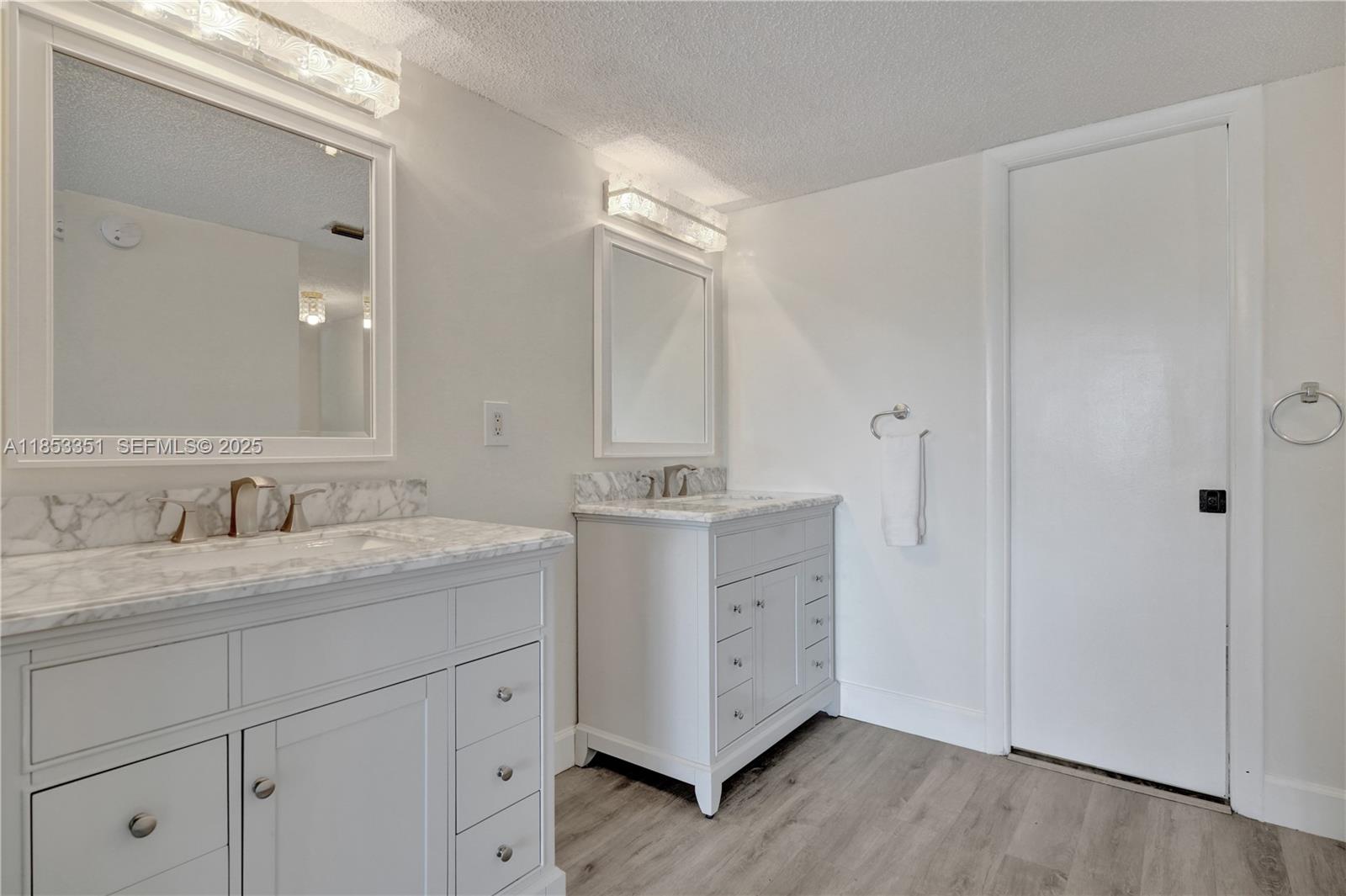 873 Northeast 195th Street, Unit 309 North Miami Beach, FL 33179 - Photo 17 of 35 a bathroom with a granite countertop sink mirror and double