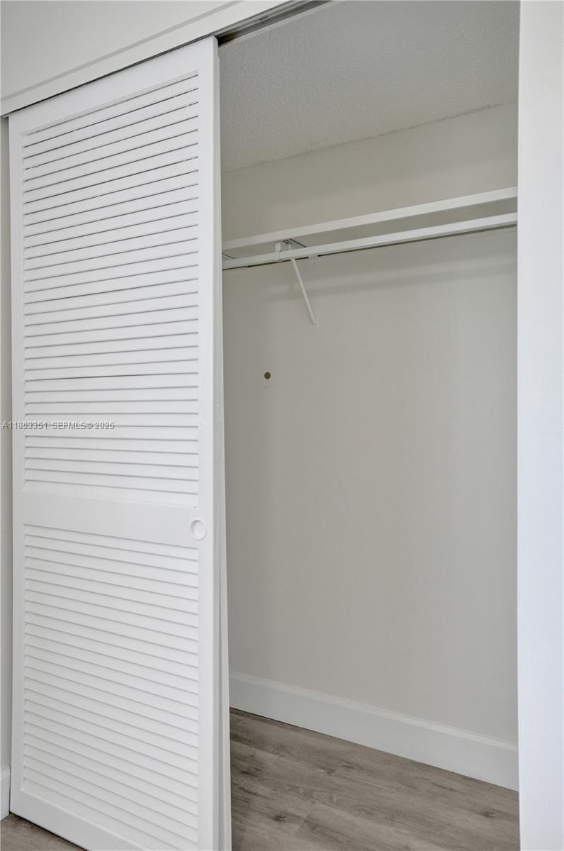 873 Northeast 195th Street, Unit 309 North Miami Beach, FL 33179 - Photo 18 of 35 a view of a closet