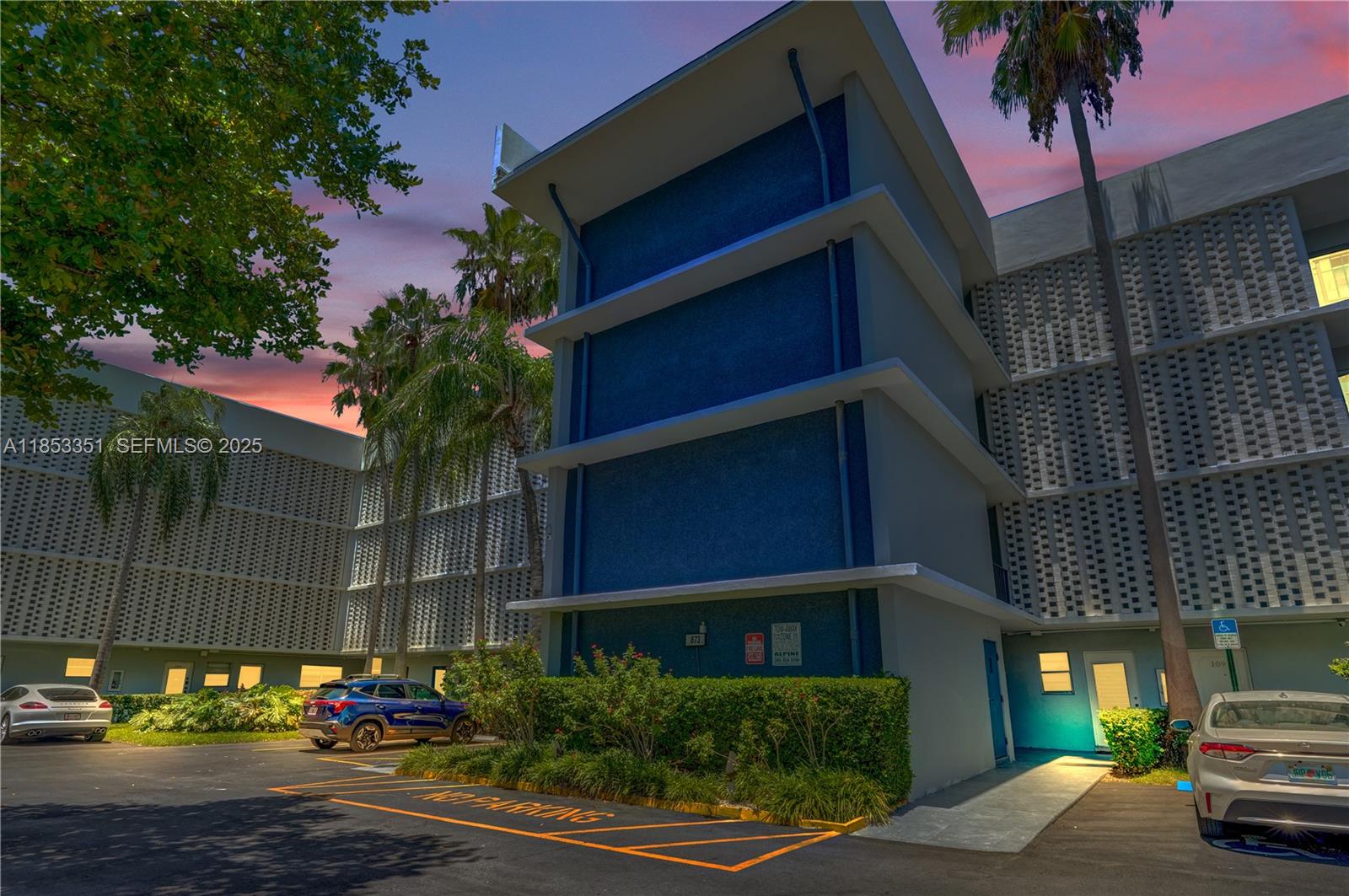 873 Northeast 195th Street, Unit 309 North Miami Beach, FL 33179 - Photo 2 of 35 a car parked in front of a building