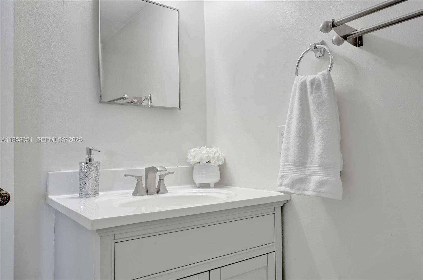 873 Northeast 195th Street, Unit 309 North Miami Beach, FL 33179 - Photo 23 of 35 a bathroom with a sink and a mirror