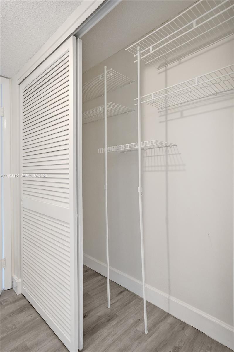 873 Northeast 195th Street, Unit 309 North Miami Beach, FL 33179 - Photo 24 of 35 a view of a room with wooden floor