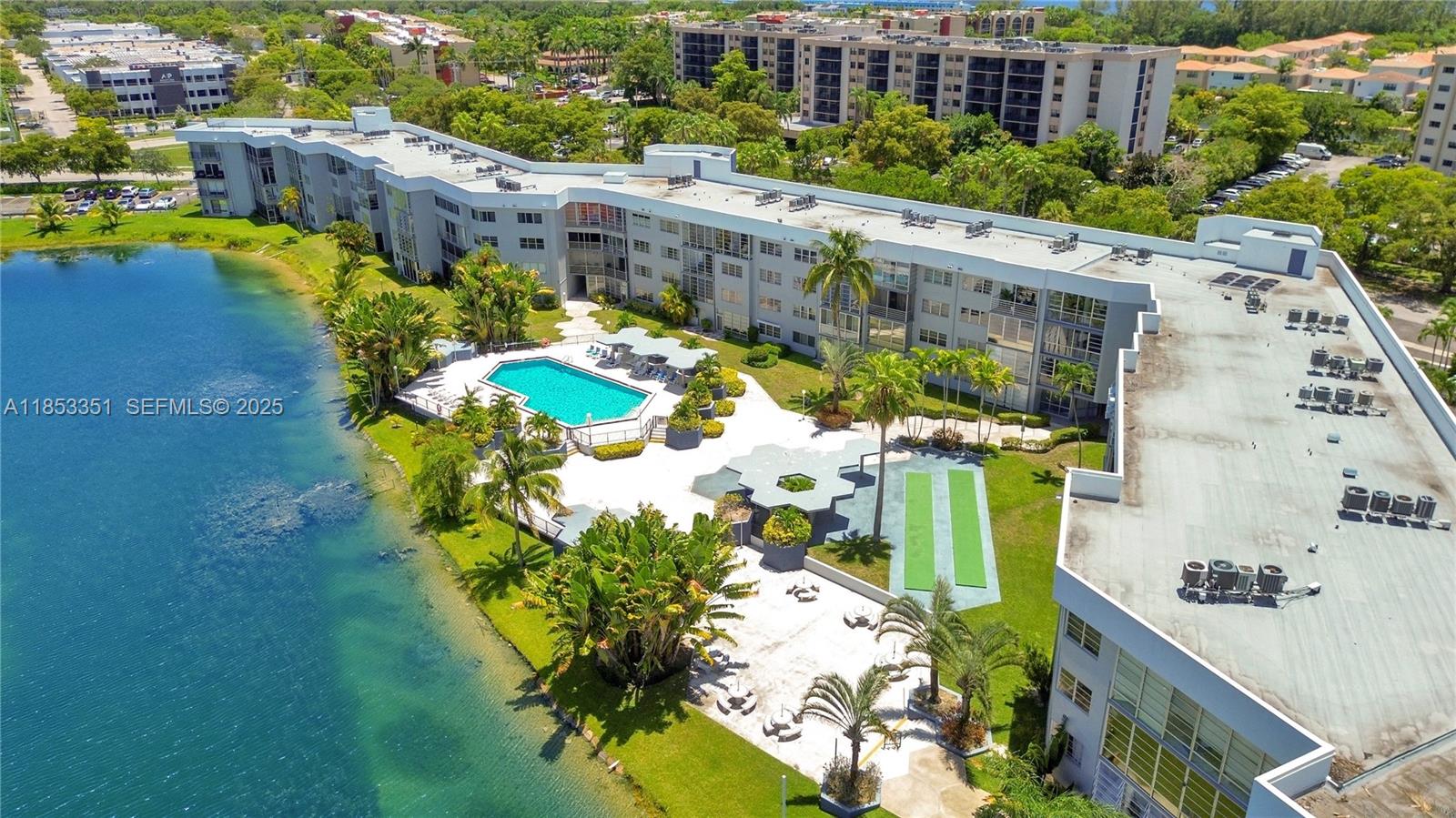 873 Northeast 195th Street, Unit 309 North Miami Beach, FL 33179 - Photo 26 of 35 a view of a swimming pool with a patio