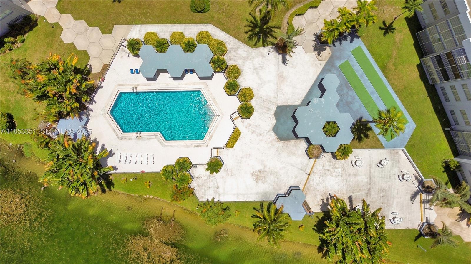 873 Northeast 195th Street, Unit 309 North Miami Beach, FL 33179 - Photo 27 of 35 an aerial view of a swimming pool