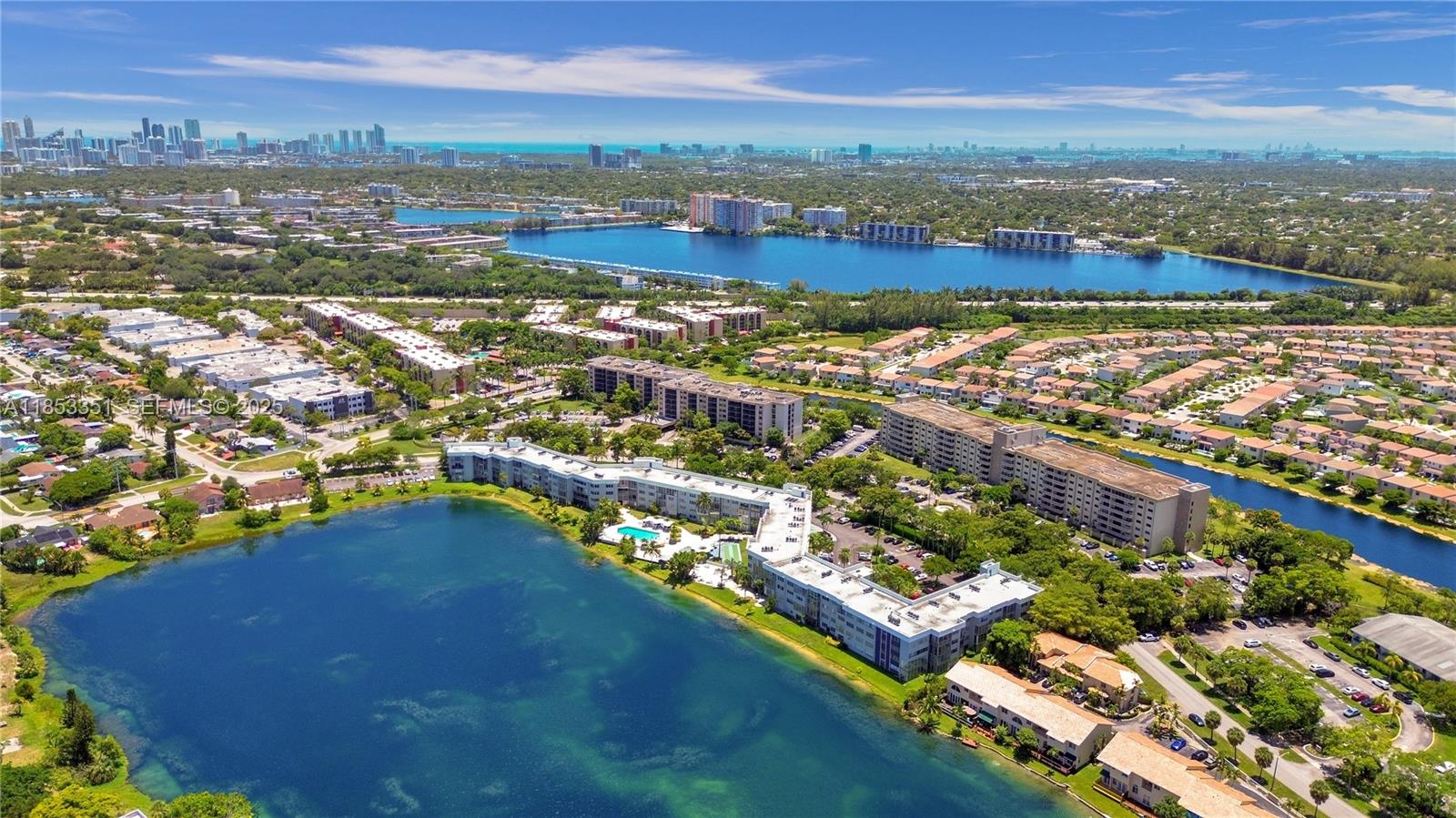 873 Northeast 195th Street, Unit 309 North Miami Beach, FL 33179 - Photo 33 of 35 an aerial view of residential houses with outdoor space and river