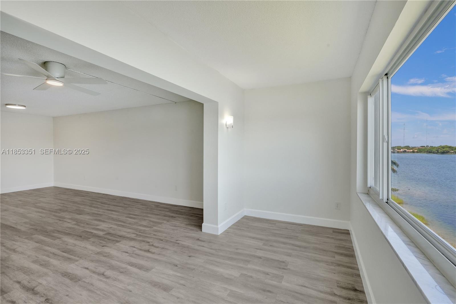 873 Northeast 195th Street, Unit 309 North Miami Beach, FL 33179 - Photo 7 of 35 a view of an empty room and window