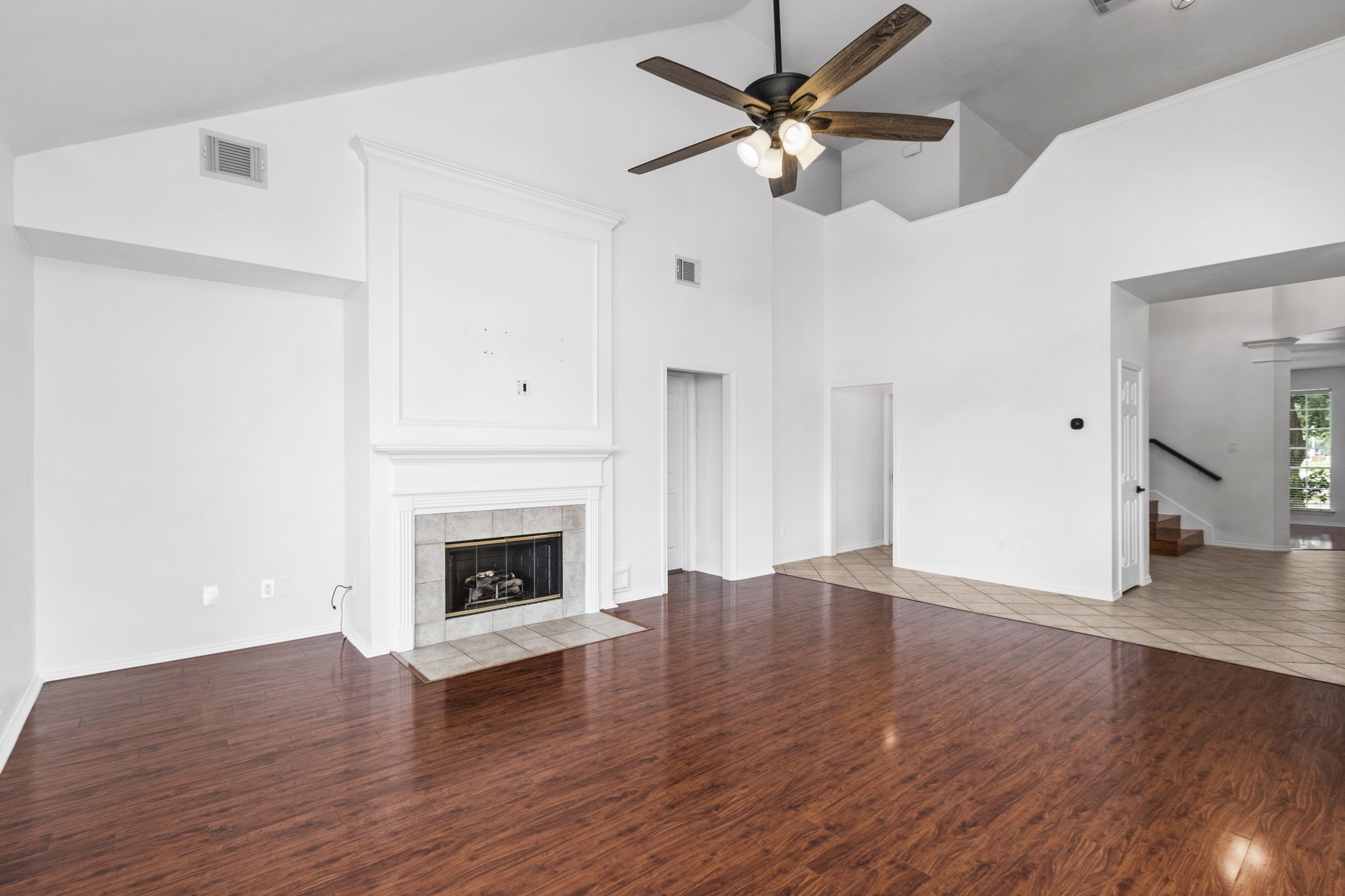 16202 Lasting Light Lane Houston, TX 77095 - Photo 12 of 36 an empty room with wooden floor fireplace fan and windows