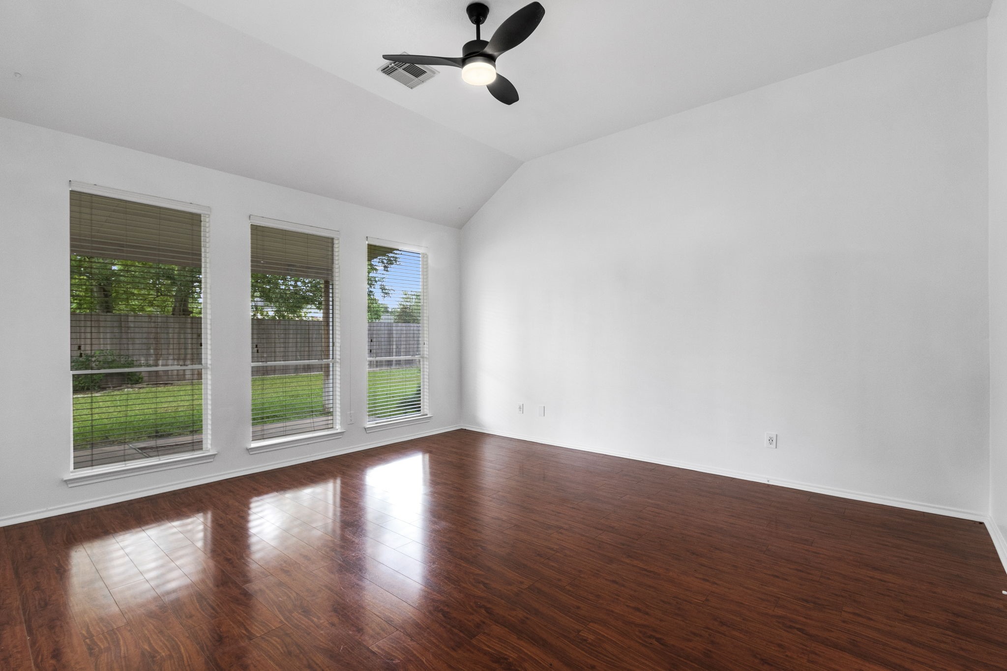 16202 Lasting Light Lane Houston, TX 77095 - Photo 18 of 36 a view of an empty room with wooden floor and a window