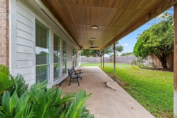 a view of a house with a yard and sitting area