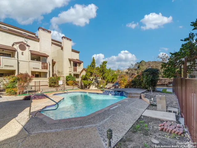 a view of a swimming pool with a patio
