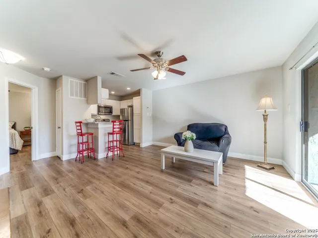a living room with furniture and kitchen view