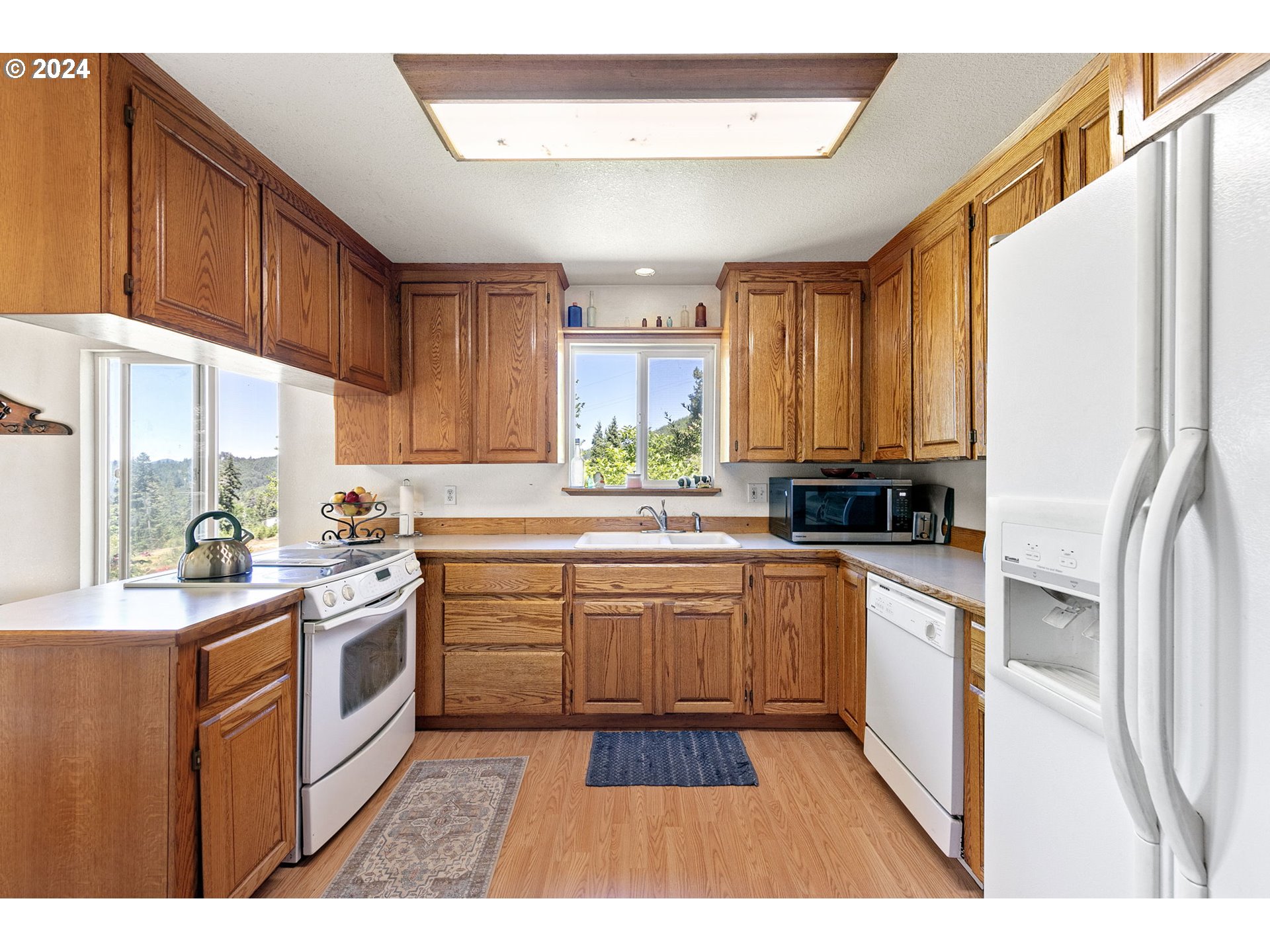 6551 Elkhead Road Yoncalla, OR 97499 - Photo 13 of 39 a kitchen with a sink stove and cabinets