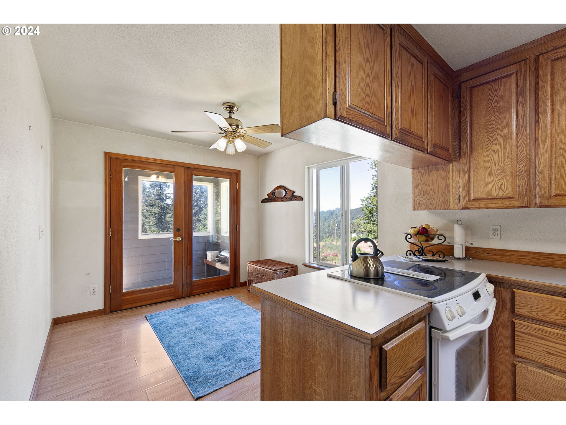 6551 Elkhead Road Yoncalla, OR 97499 - Photo 15 of 39 a kitchen with a sink cabinets and window