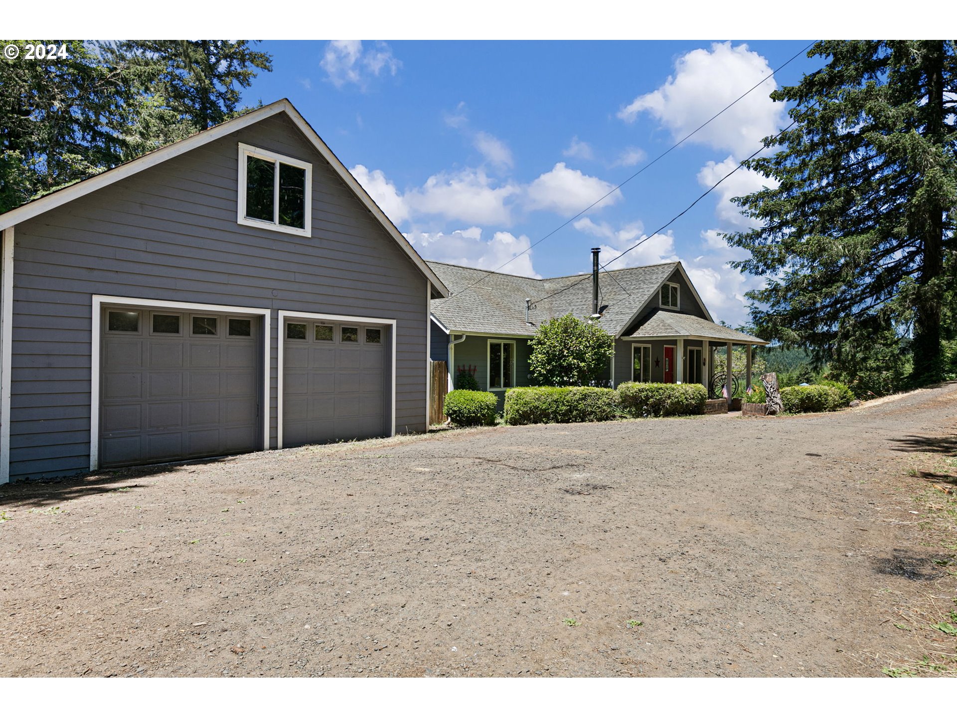 6551 Elkhead Road Yoncalla, OR 97499 - Photo 2 of 39 a front view of a house with a yard and garage