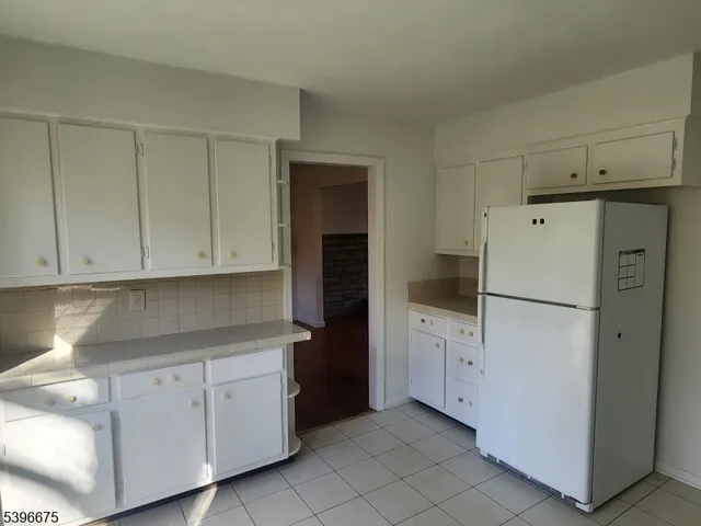 a white refrigerator freezer sitting in a kitchen