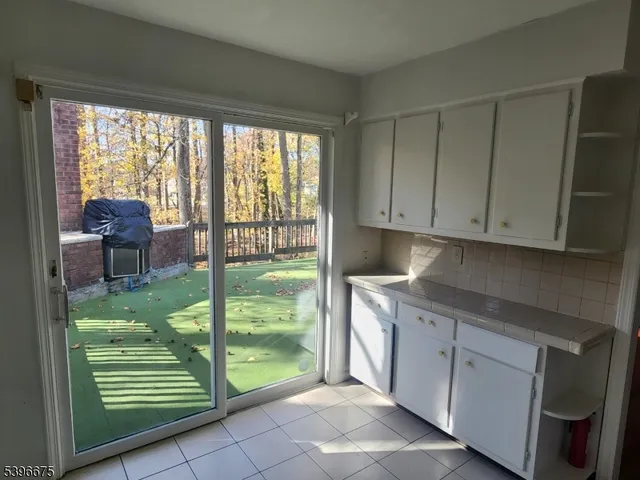 a kitchen with white cabinets and a sink