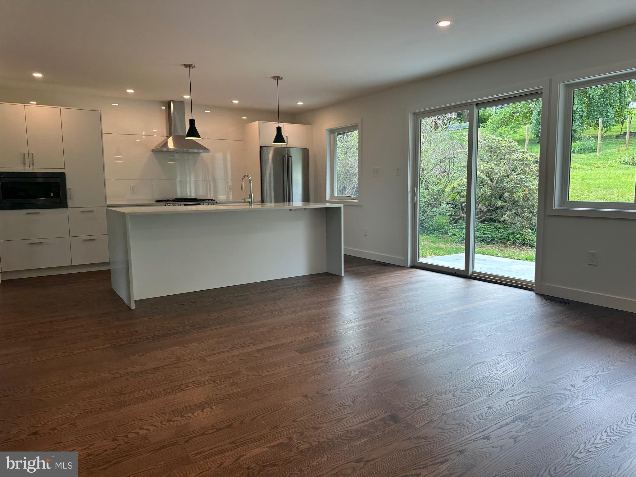 713 Woodfield Road Villanova, PA 19085 - Photo 9 of 36 a view of kitchen with wooden floor and window