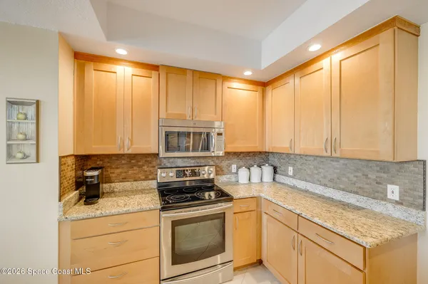 a dining room with furniture a chandelier and wooden floor