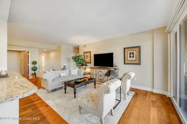 a living room with fireplace furniture and a large window