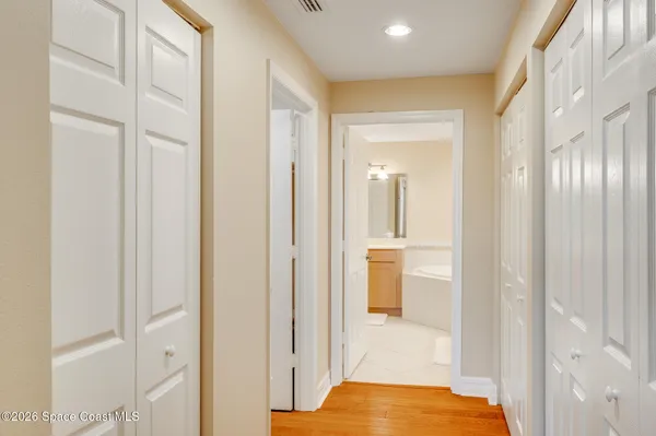 a white toilet sitting next to a wooden cabinet