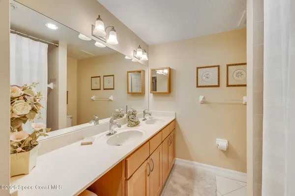 a living room with a couch and a potted plant