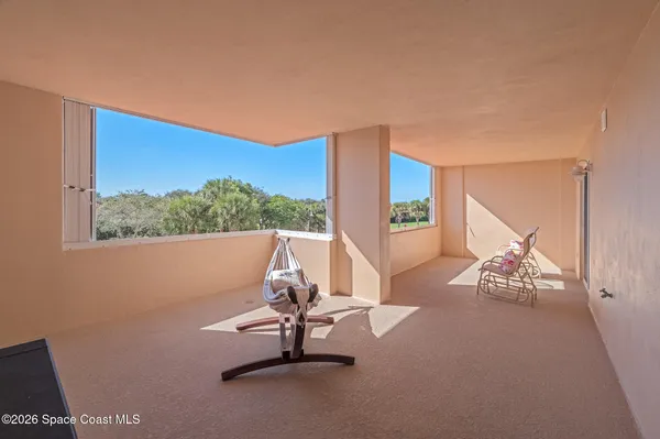 an aerial view of a residential houses with outdoor space and seating area