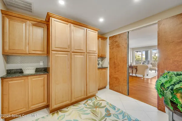 a view of a room with potted plants wooden floor and a chandelier
