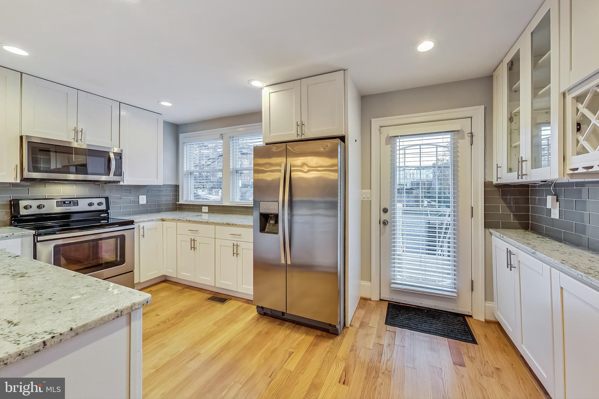 5415 Illinois Avenue Northwest Washington, DC 20011 - Photo 15 of 44 a kitchen with stainless steel appliances granite countertop a refrigerator a stove top oven a sink and dishwasher