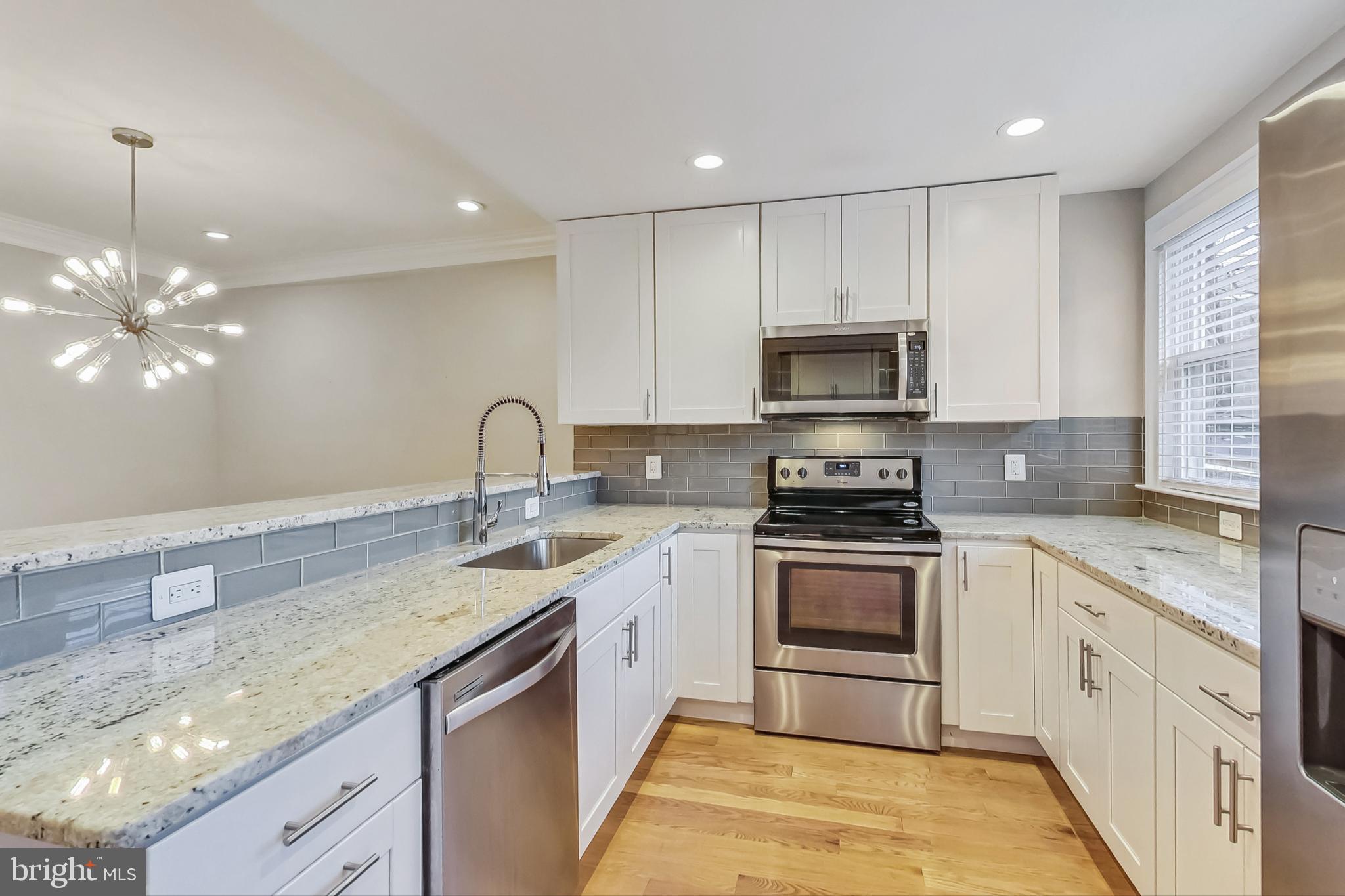 5415 Illinois Avenue Northwest Washington, DC 20011 - Photo 16 of 44 a kitchen with granite countertop a stove and a sink