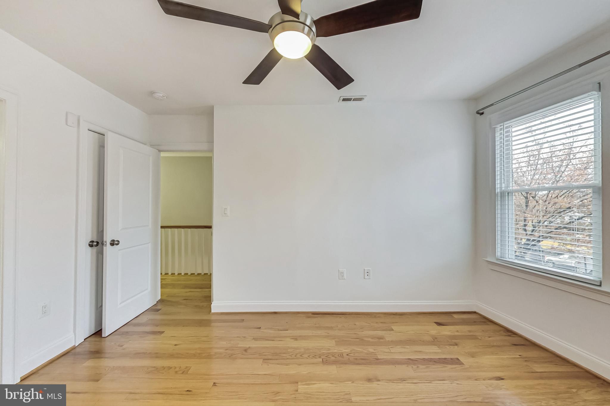 5415 Illinois Avenue Northwest Washington, DC 20011 - Photo 21 of 44 a view of an empty room with window and wooden floor