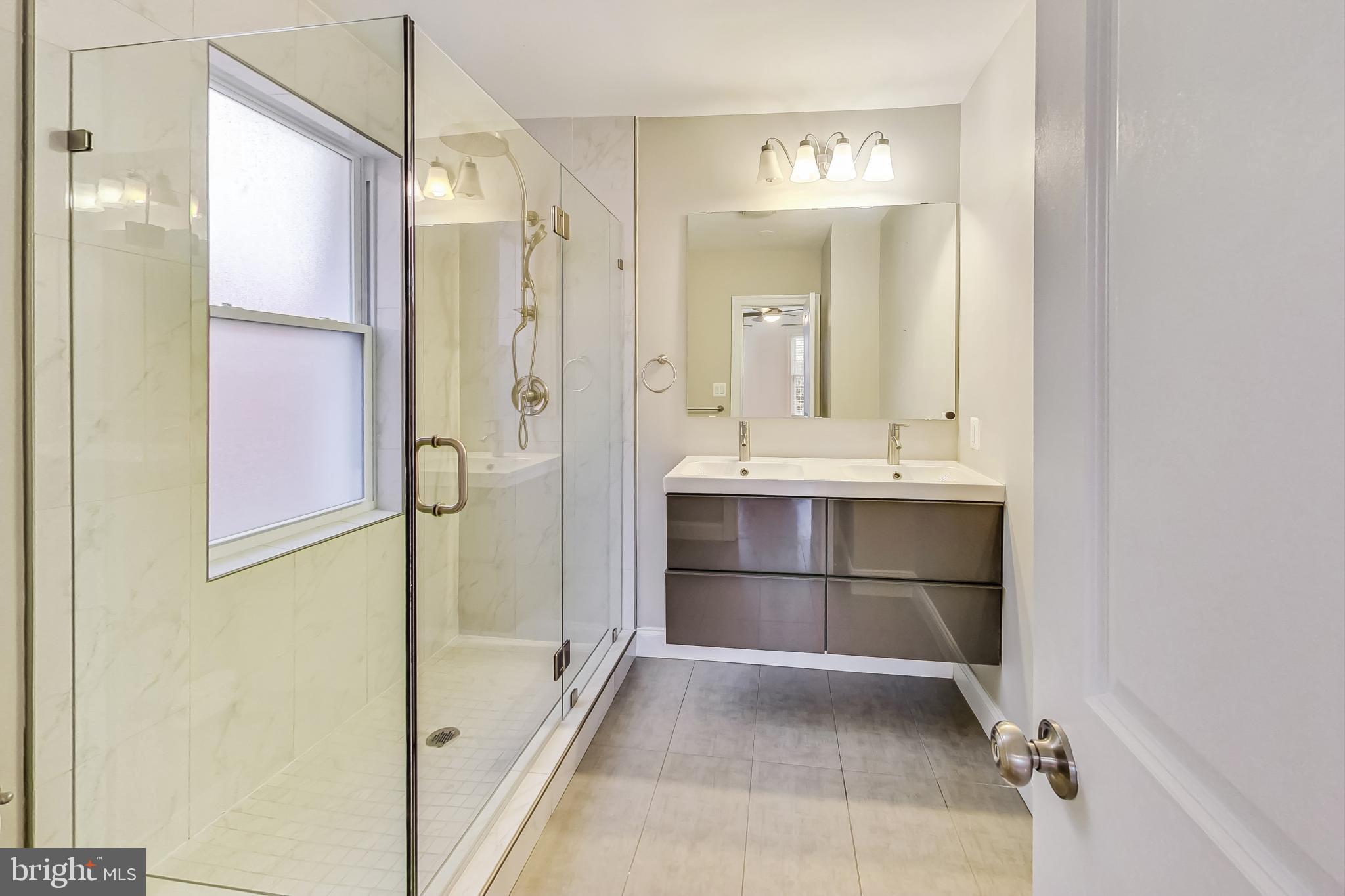 5415 Illinois Avenue Northwest Washington, DC 20011 - Photo 22 of 44 a bathroom with a tub sink shower and mirror