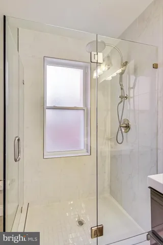 a bathroom with a glass shower door
