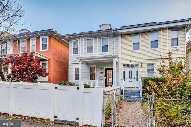 front view of a house with potted plants