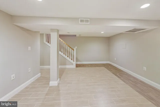 a view of an empty room with stairs