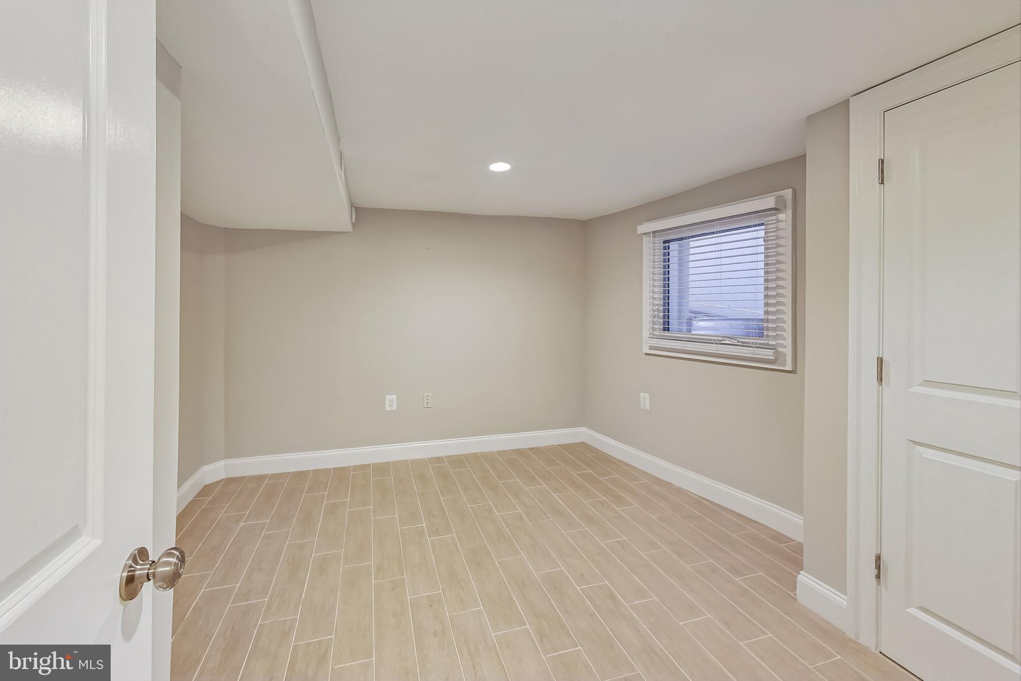 5415 Illinois Avenue Northwest Washington, DC 20011 - Photo 33 of 44 an empty room with wooden floor and windows