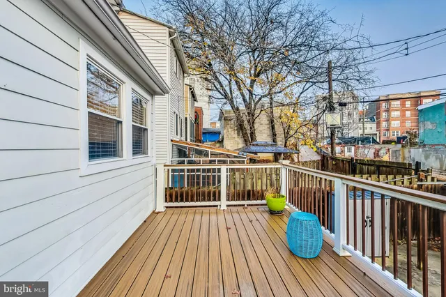 a view of a balcony with two chairs and wooden floor