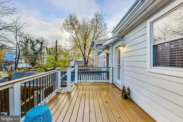 a view of balcony with wooden floor and fence and a floor to ceiling window