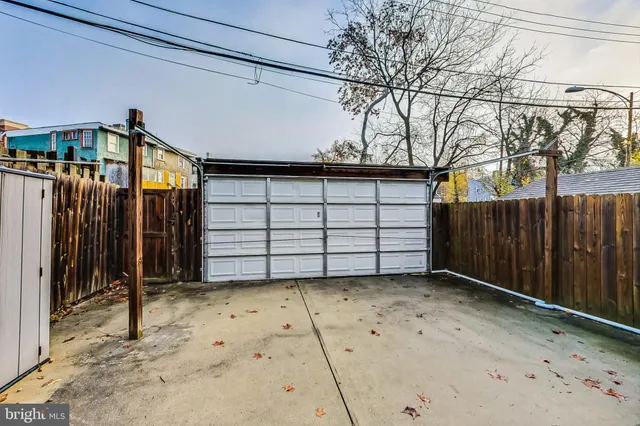 a view of a house with a wooden fence