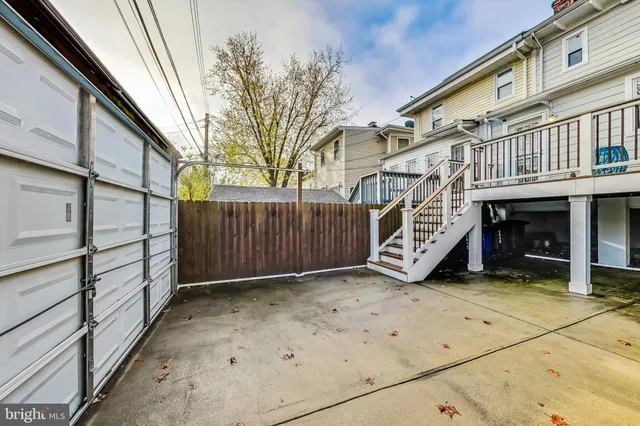 a view of a house with a wooden fence