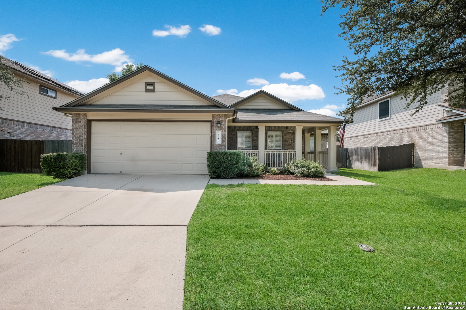 9250 Cedar Point Helotes, TX 78023 - Photo 1 of 1 a front view of a house with a yard and garage