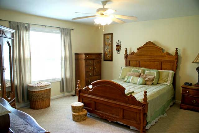 2023 Clara Mathis Road Spring Hill, TN 37174 - Photo 8 of 16 a bedroom with a bed and a chandelier