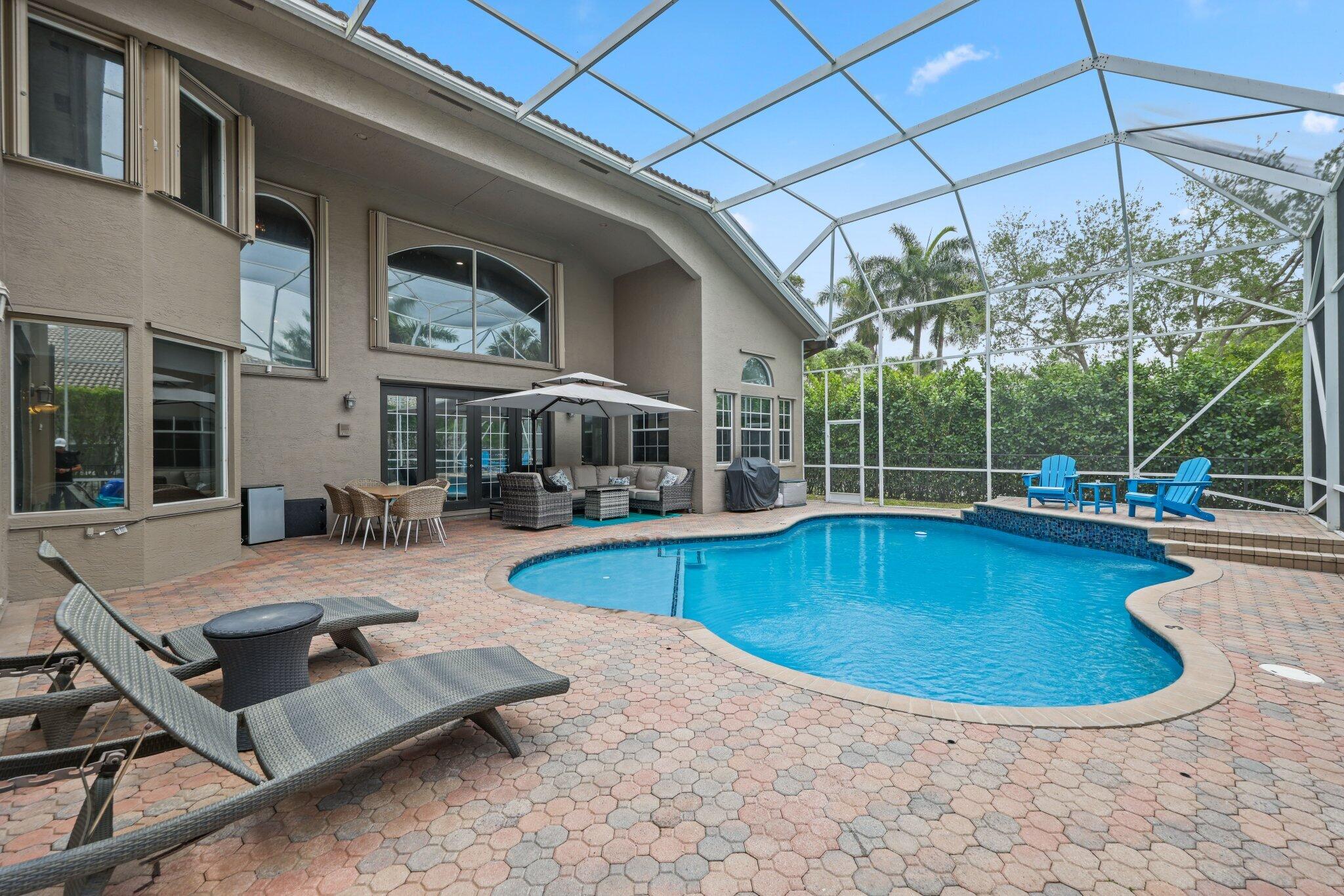 19219 North Creekshore Court Boca Raton, FL 33498 - Photo 27 of 73 a view of a house with swimming pool and sitting area
