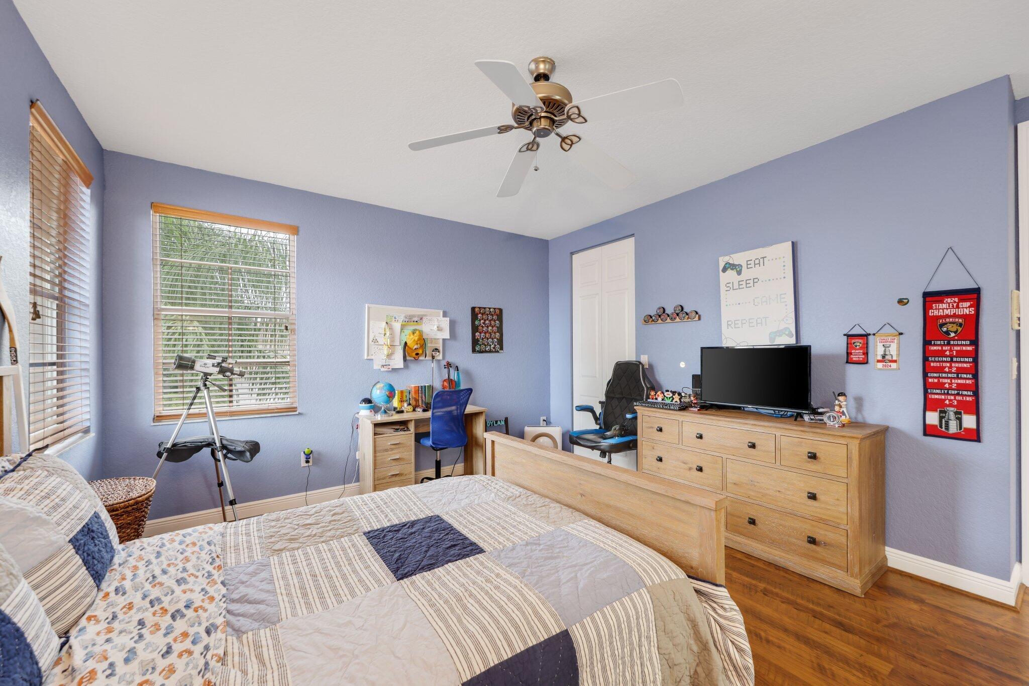 19219 North Creekshore Court Boca Raton, FL 33498 - Photo 55 of 73 a bedroom with a bed and furniture with wooden floor