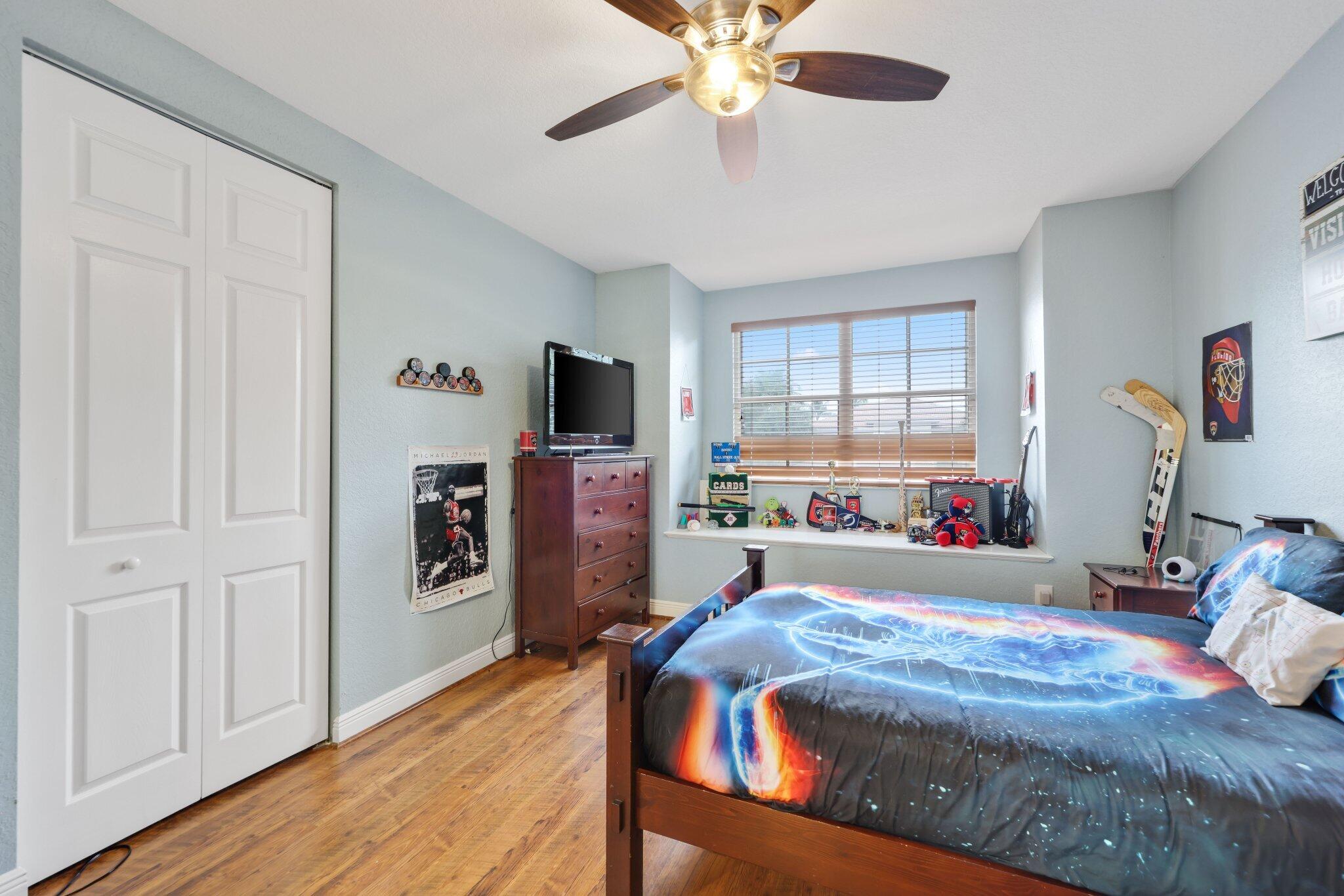 19219 North Creekshore Court Boca Raton, FL 33498 - Photo 57 of 73 a bedroom with a bed and a flat screen tv