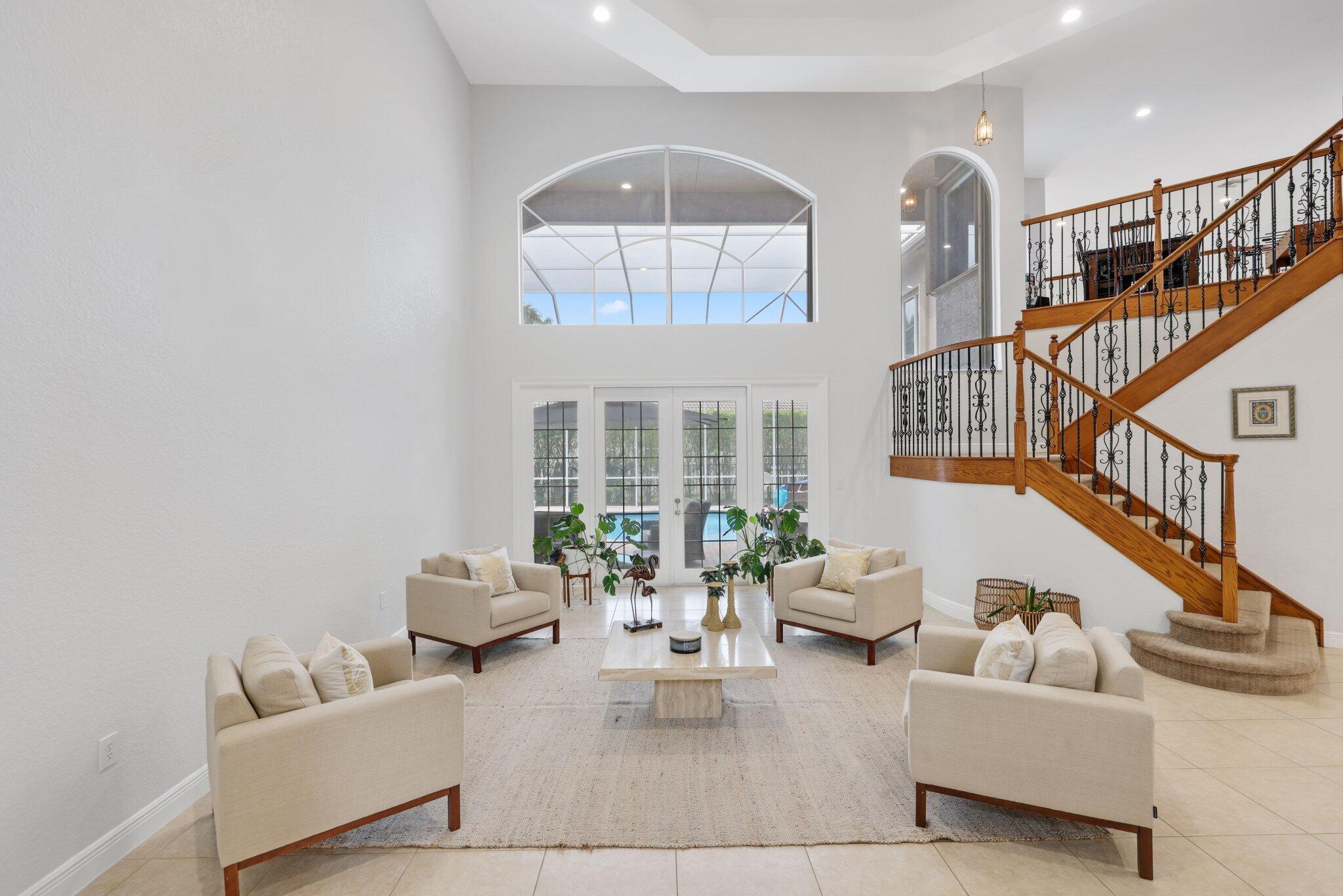 19219 North Creekshore Court Boca Raton, FL 33498 - Photo 8 of 73 a living room with furniture and a chandelier