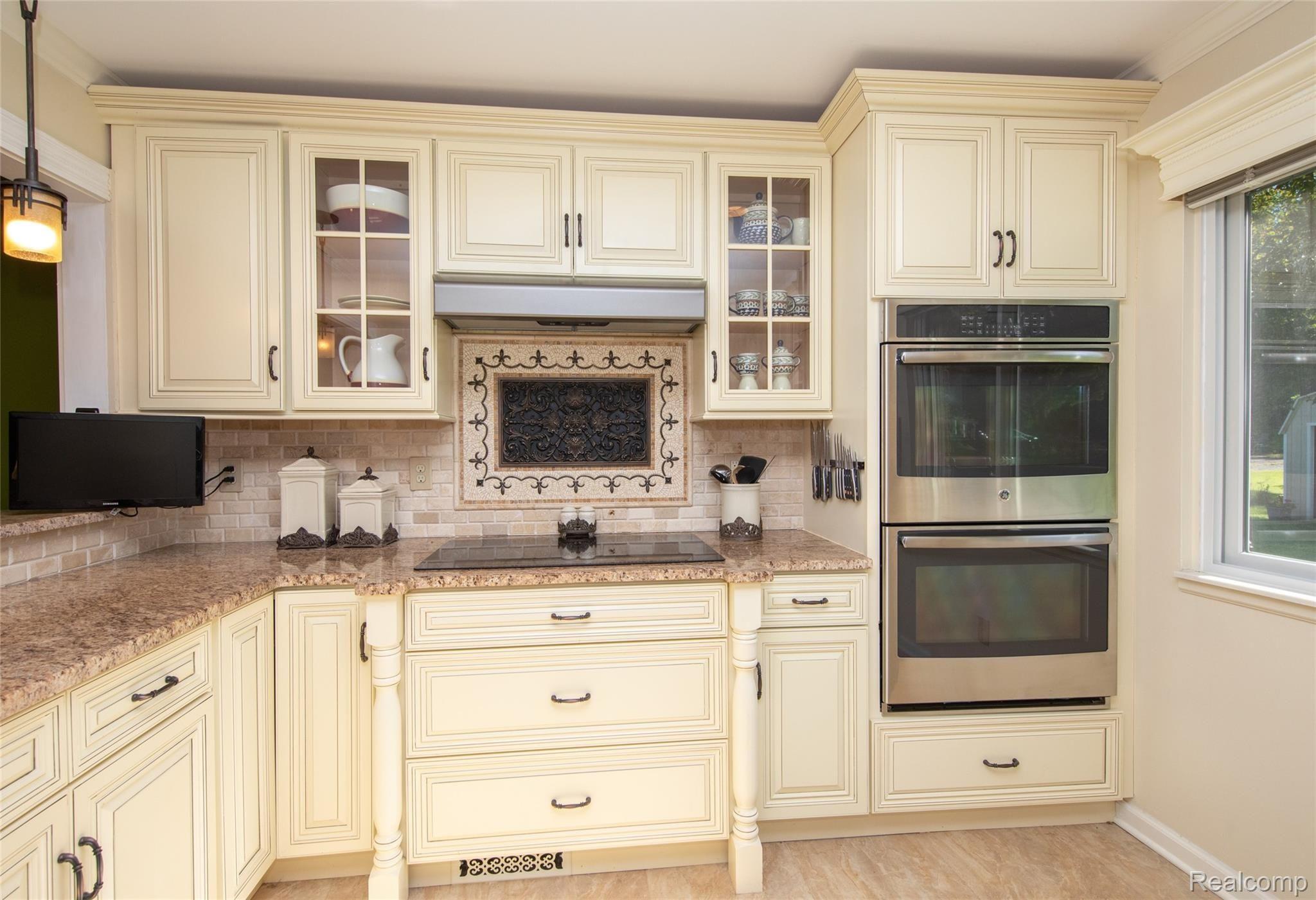 8117 Reese Road Clarkston, MI 48348 - Photo 15 of 41 Stunning kitchen with stainless steel appliances, double ovens, granite countertops, and porcelain tile flooring.