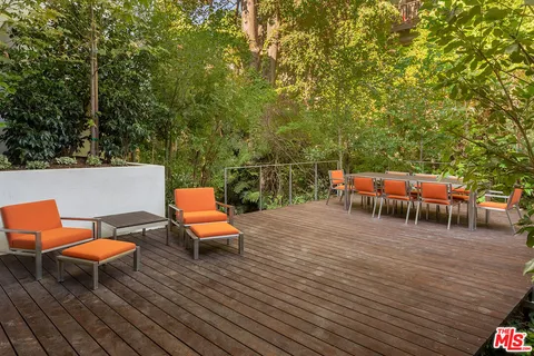 an outdoor sitting area with a couch and trees