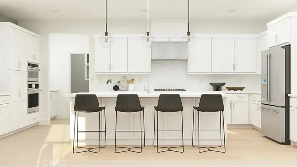 a view of kitchen with white cabinets and stainless steel appliances